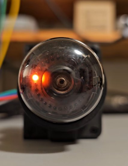 Still from the video: the A101 in its shroud, lit, the orange glow on one cathode at the left of the ring
